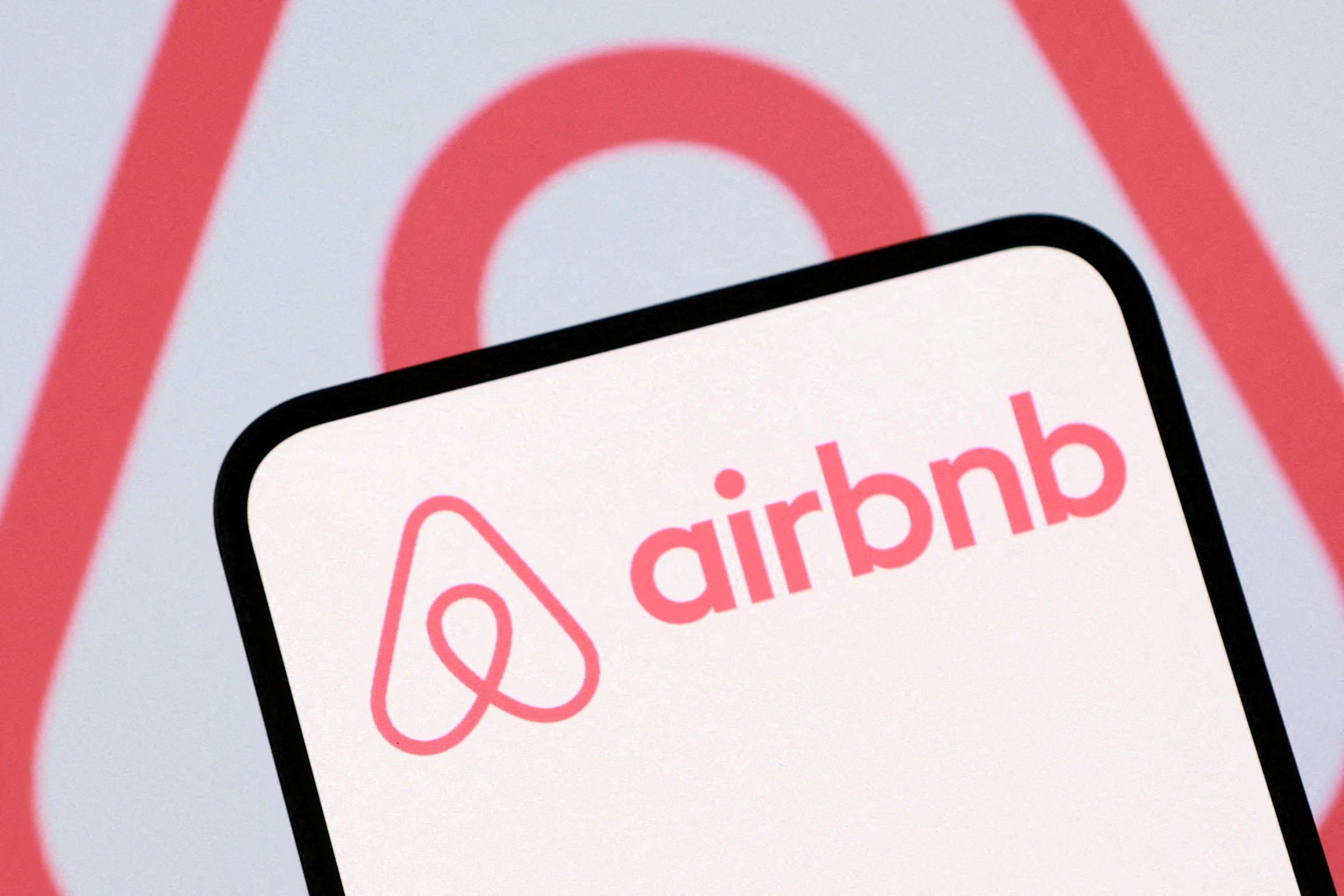 Illustration shows Airbnb logo