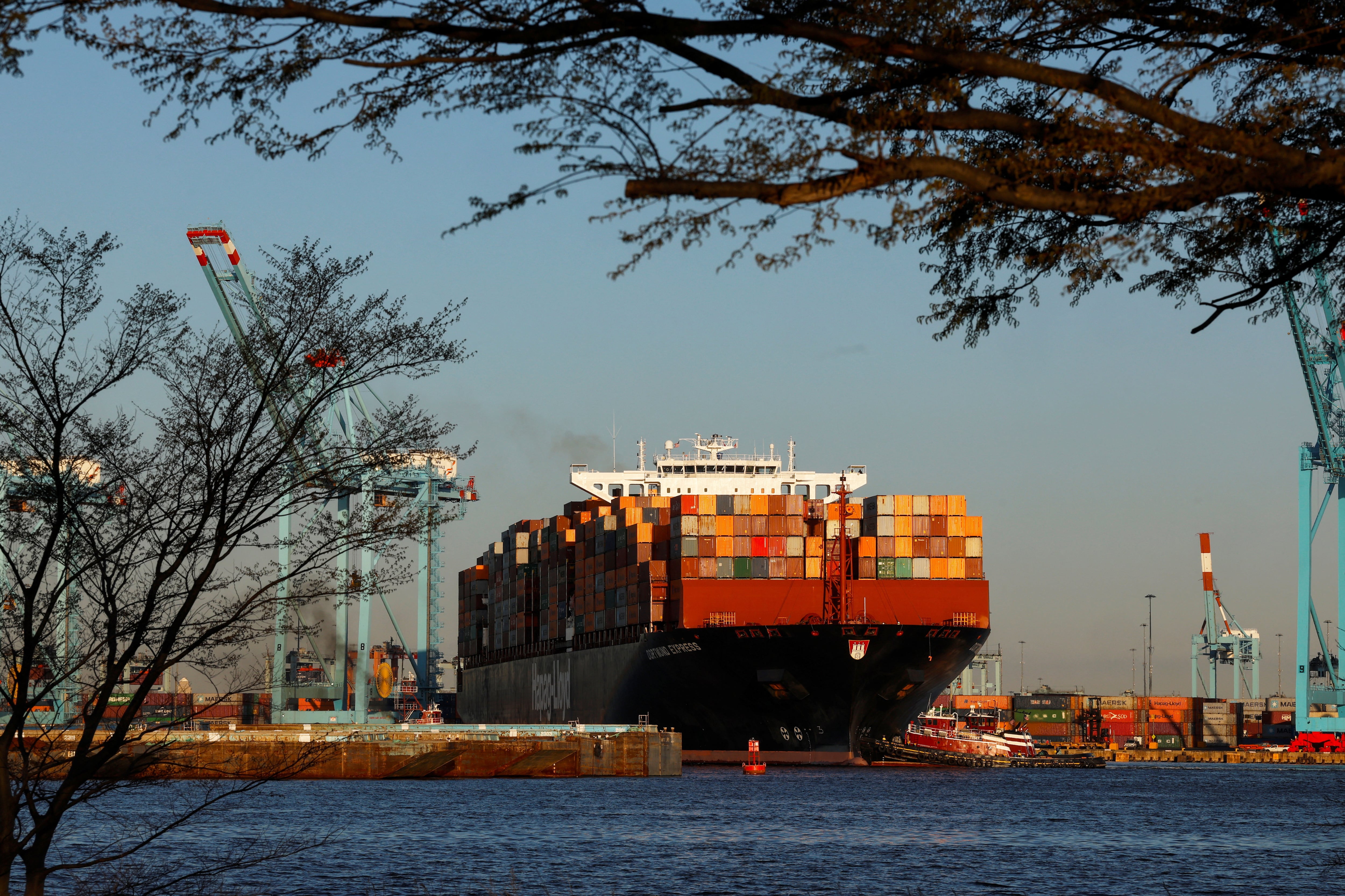 A cargo ship sits outside of the Port of Elizabeth marine terminal seen from Bayonne, New Jersey
