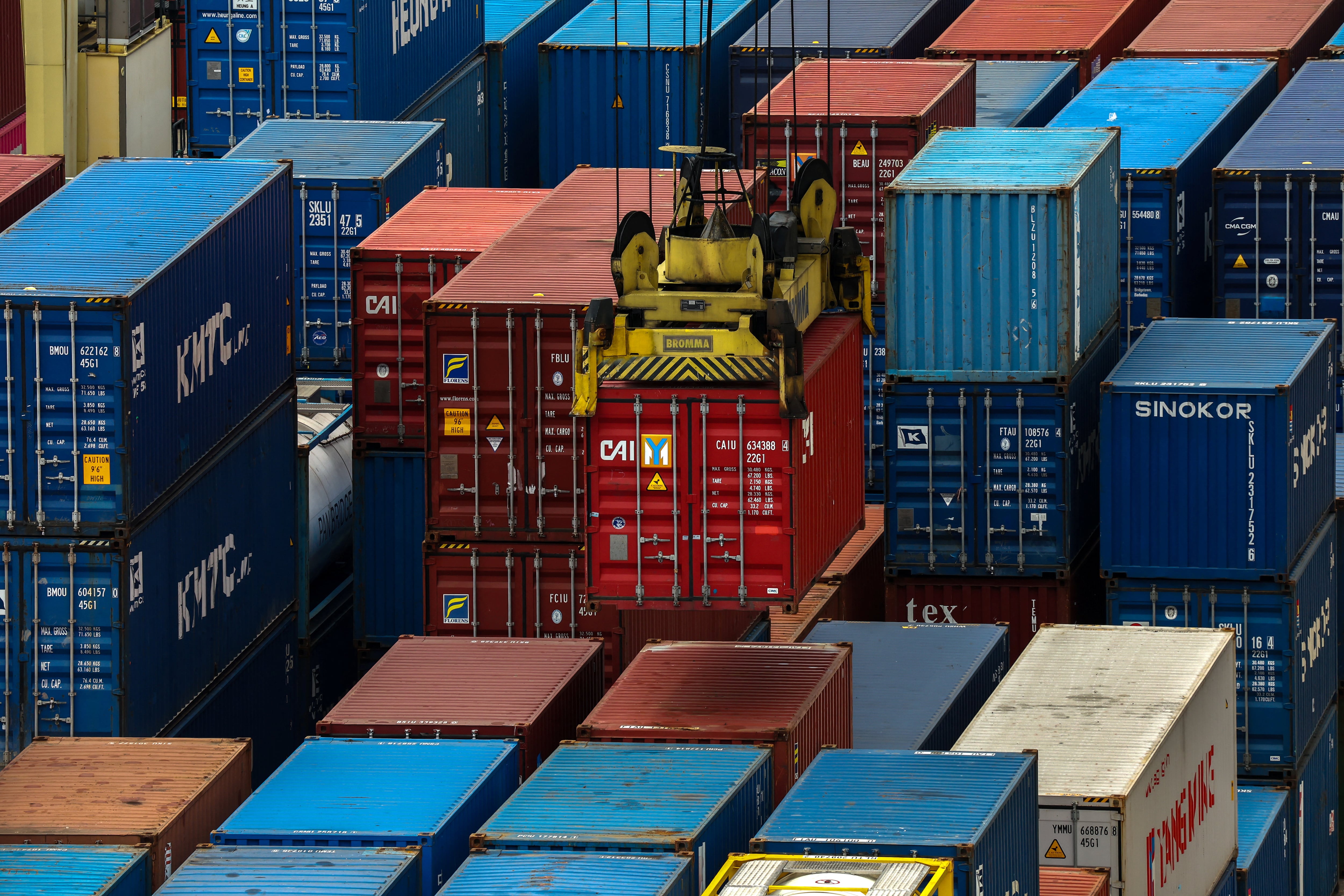 A container is loaded onto a cargo ship