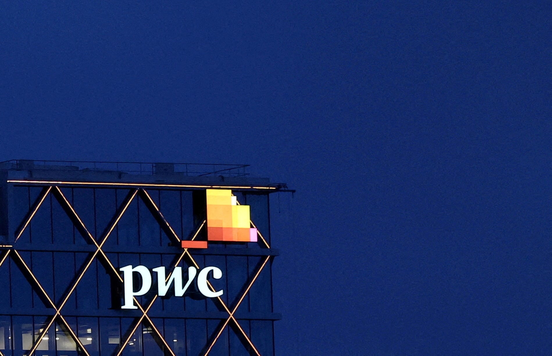 The logo of PwC is seen on the top of a Brussels' office of the company