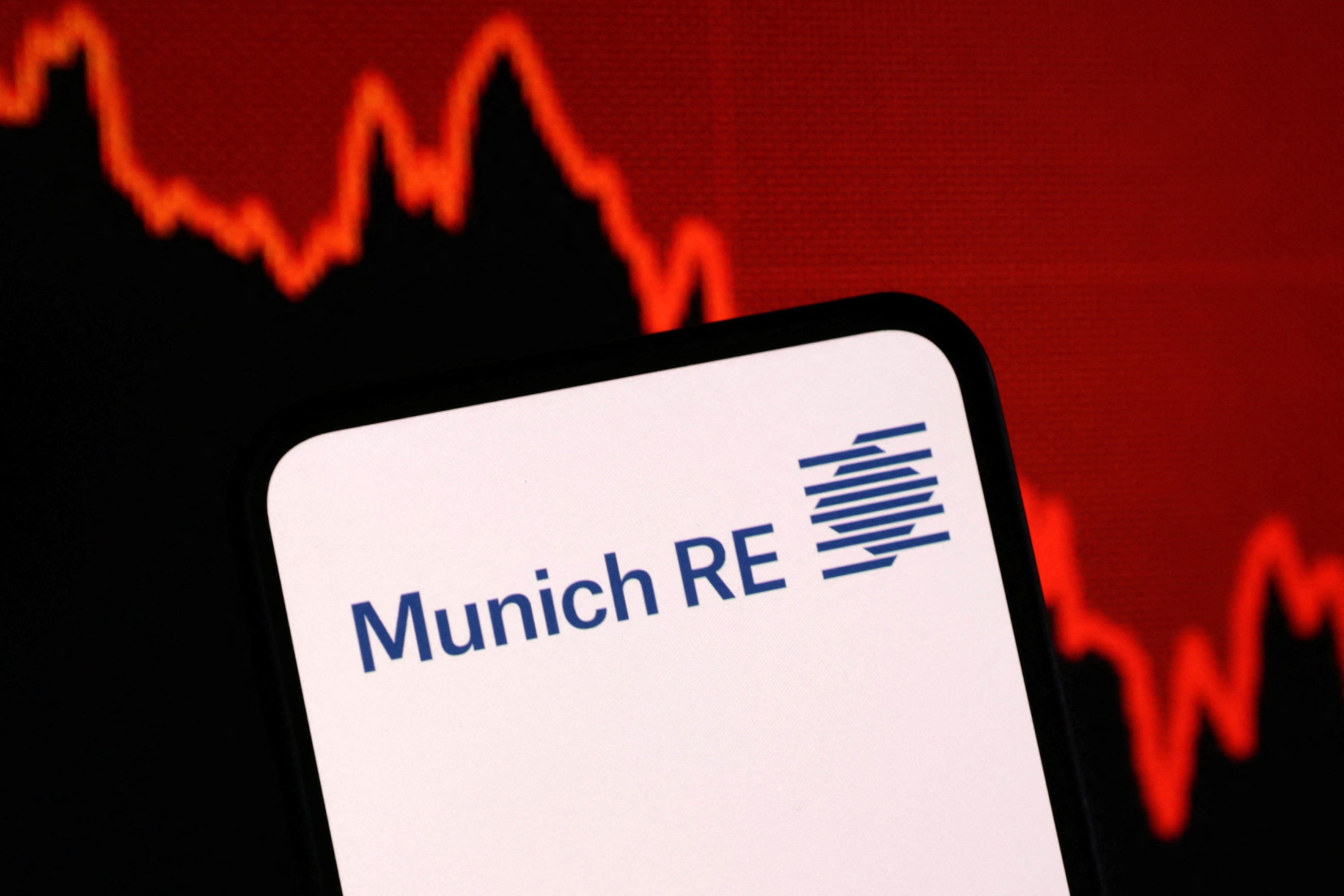 Illustration shows Munich Re logo and decreasing stock graph