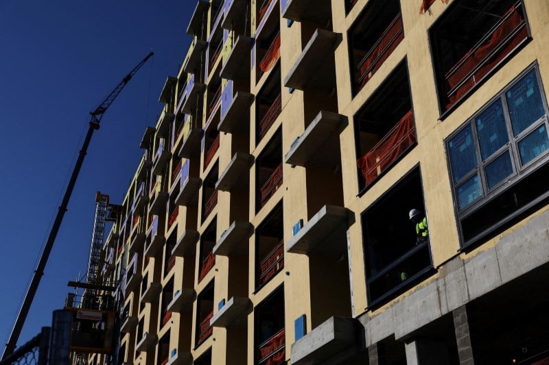 A construction worker labors inside a condominium site along the beach in Long Beach, New York, U.S.
