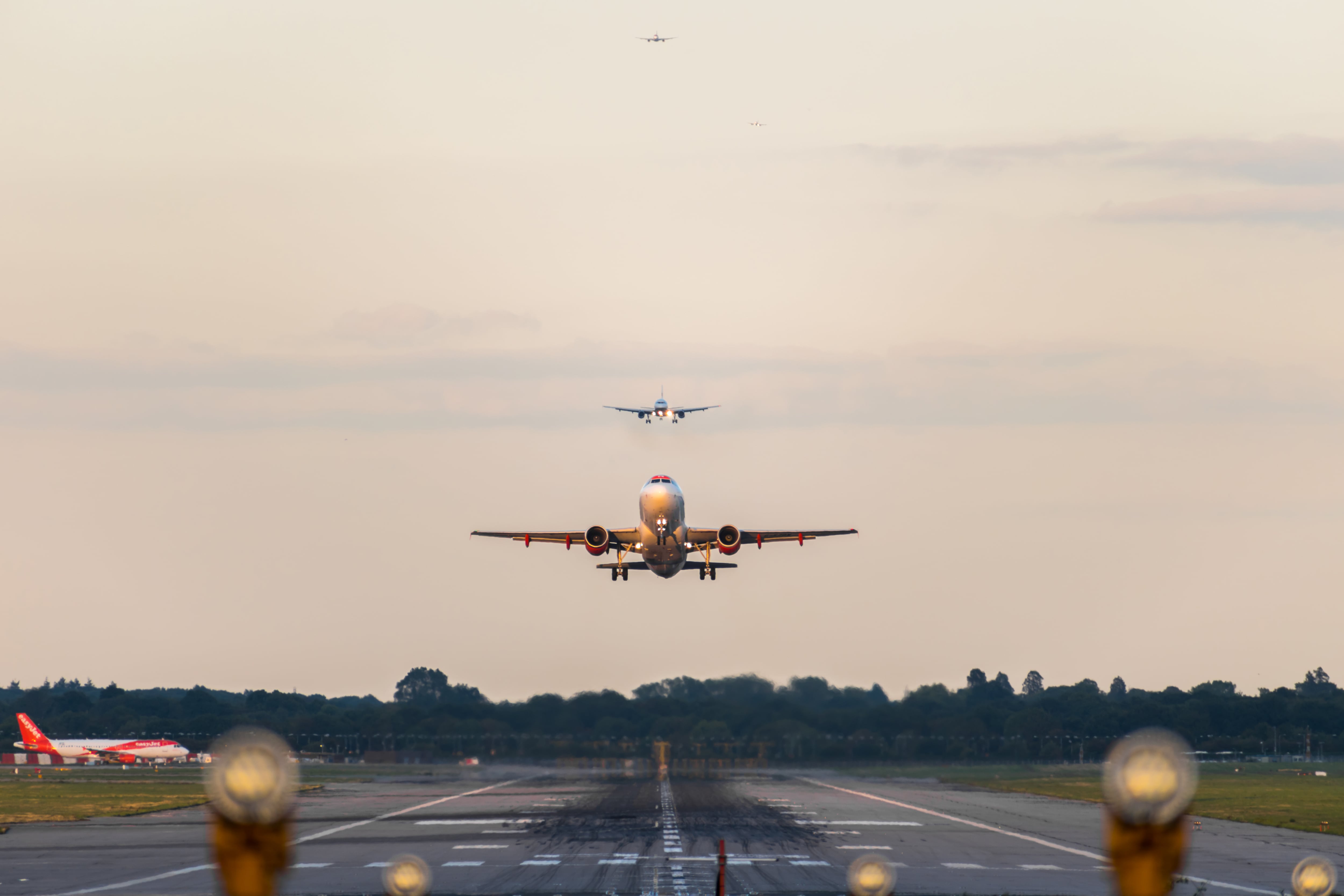GATWICK AIRPORT, ENGLAND, UK – SEPTEMBER 13 2018: View directly down the runway as an easyJet Airlines plane takes off from Gatwick Airport