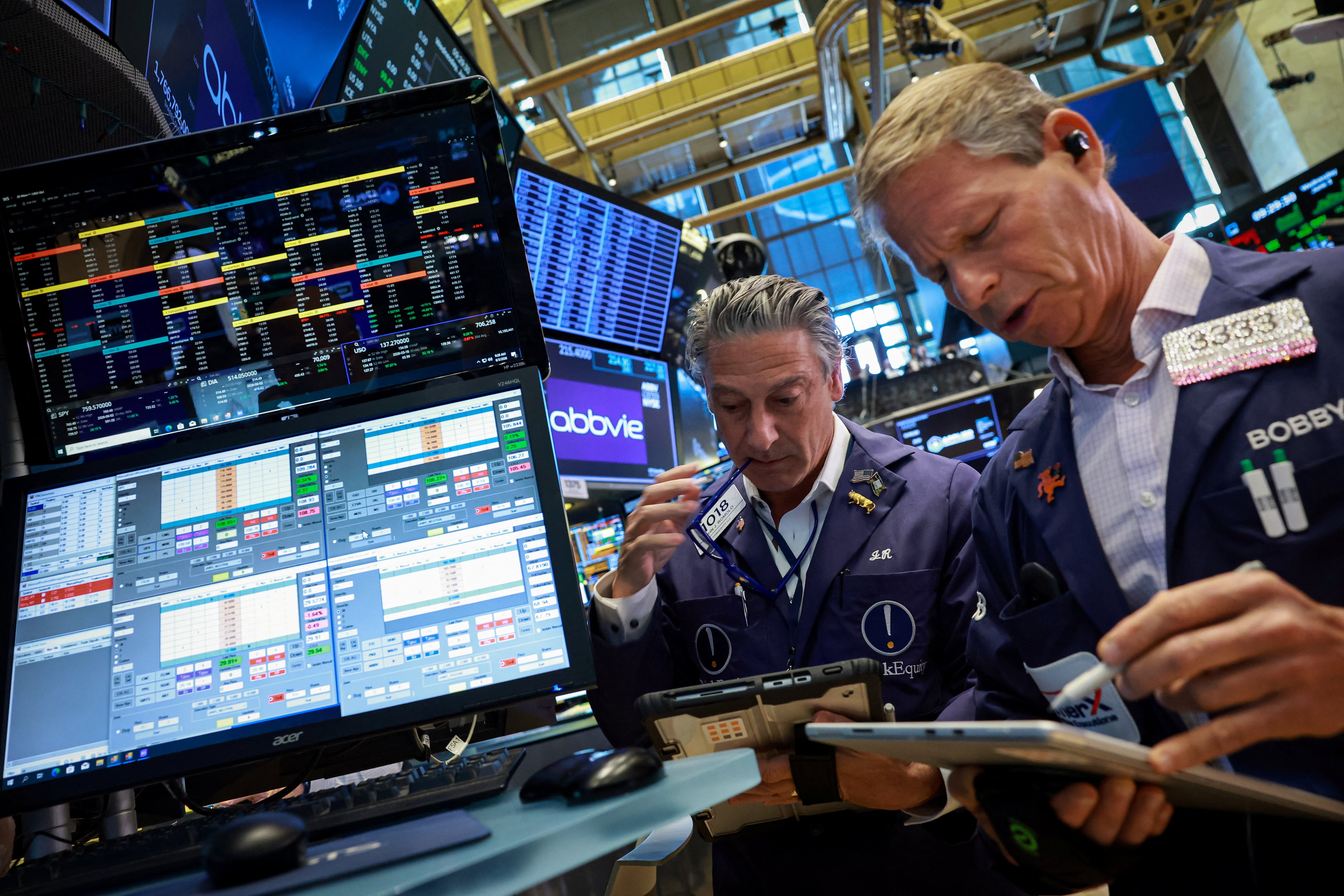 Traders work on the floor of the NYSE in New York