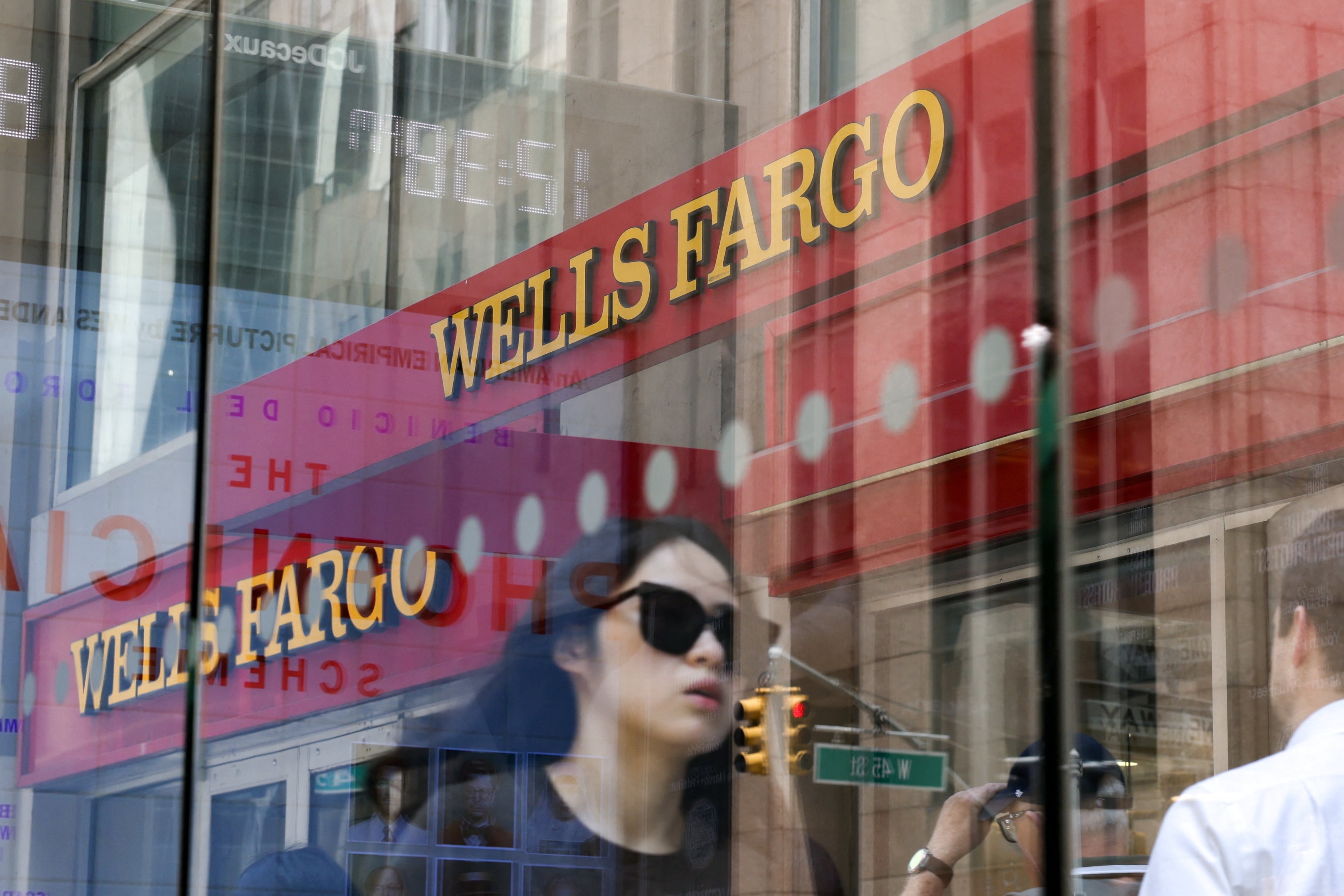 People walk by a Wells Fargo bank in New York